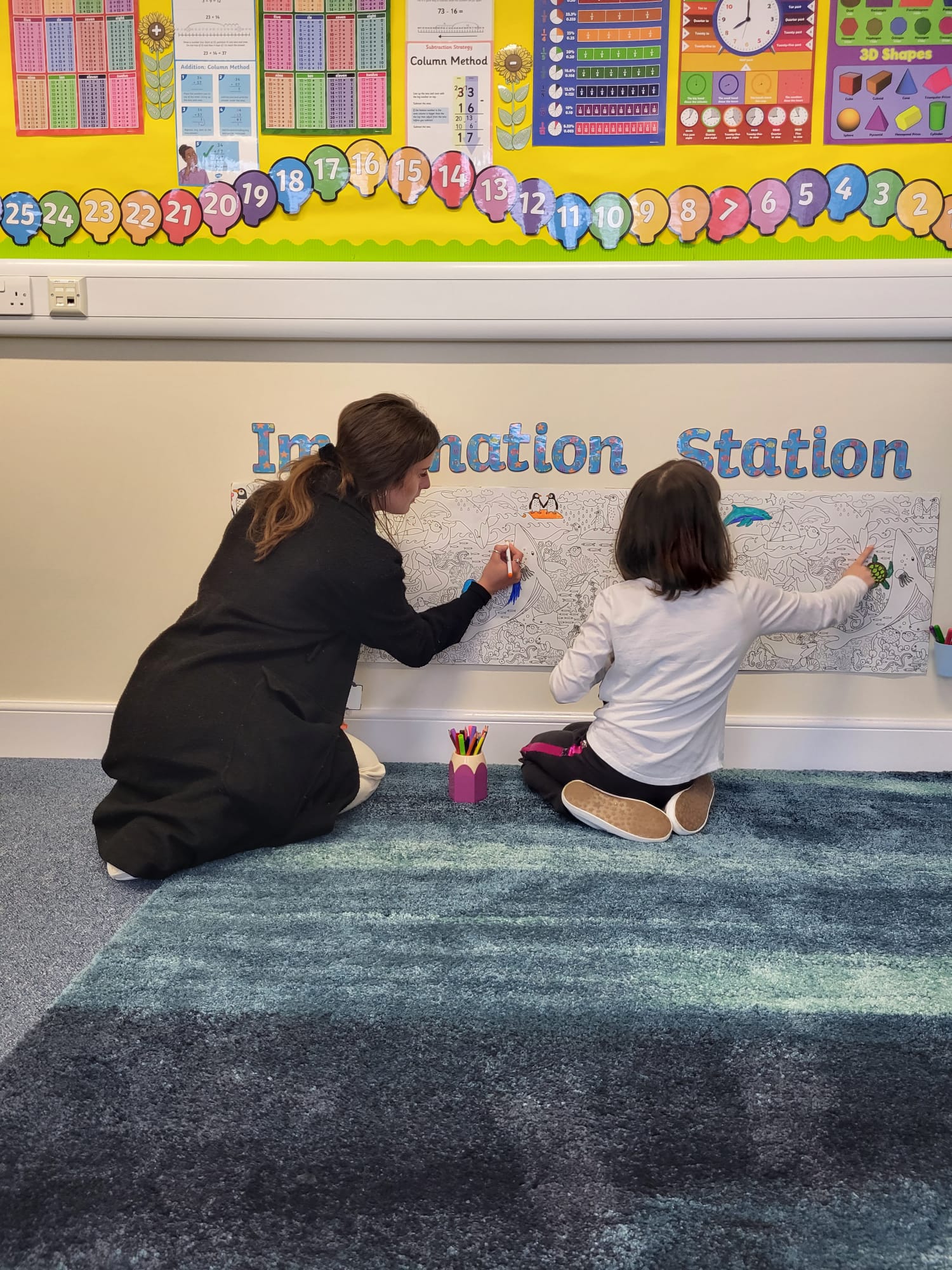 a teacher and a child learning at the imagination station