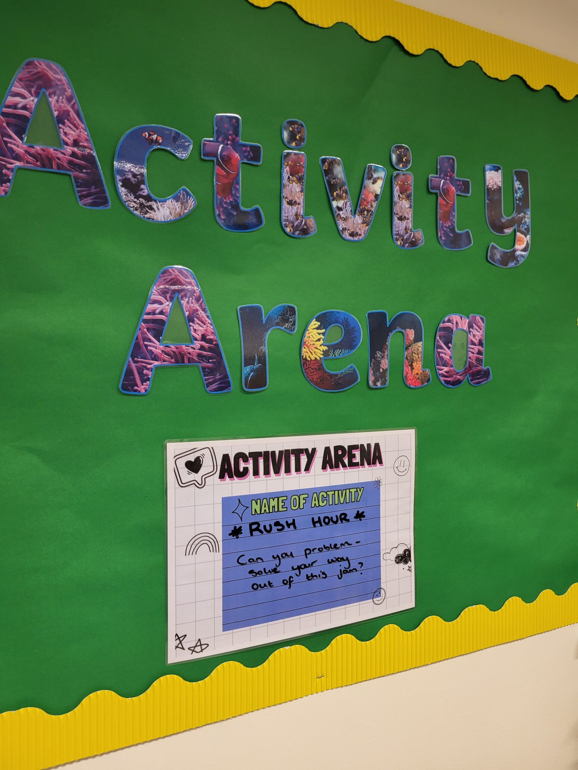 green wall with the words activity arena and a car displaying the game rush hour and asking if you can get out of the puzzle