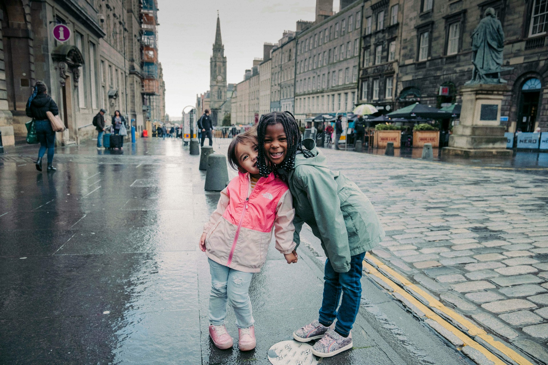 two happy primary school aged girls on street in Edinburgh