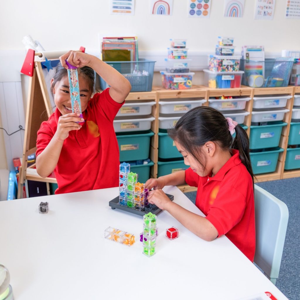 Two primary school students engage in the activity arena