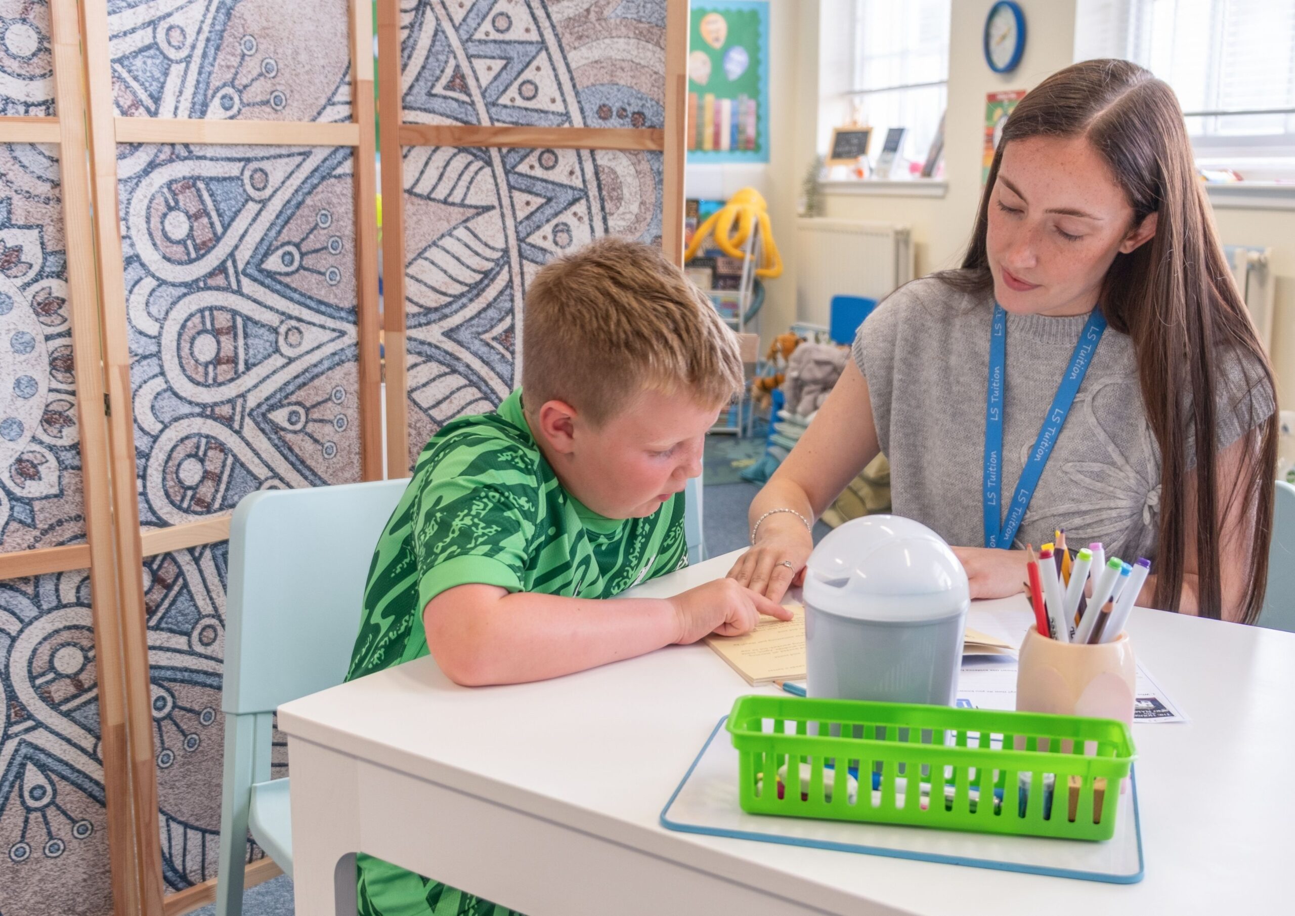 About Our Lessons: An LS Tuition tutor with a Primary School student during a literacy lesson